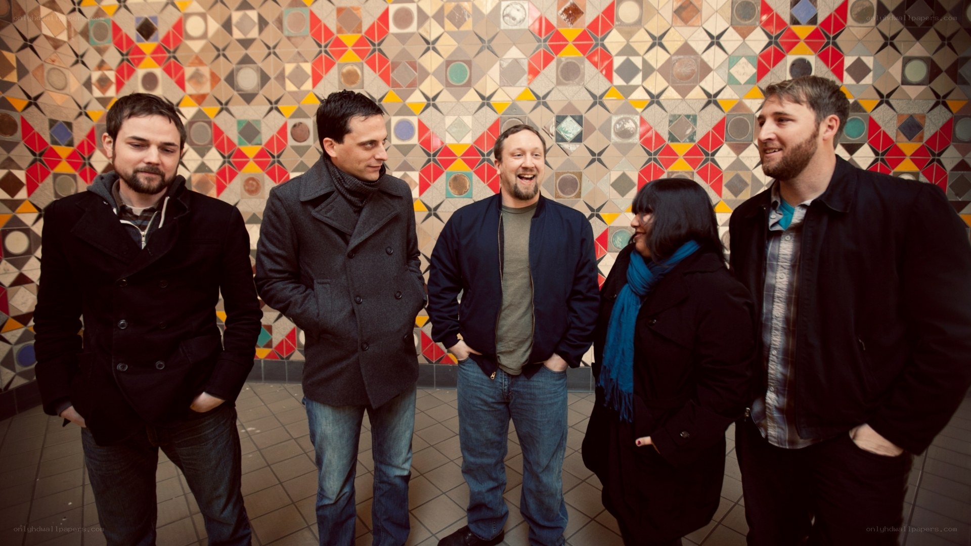 band standing in front of patterned wall