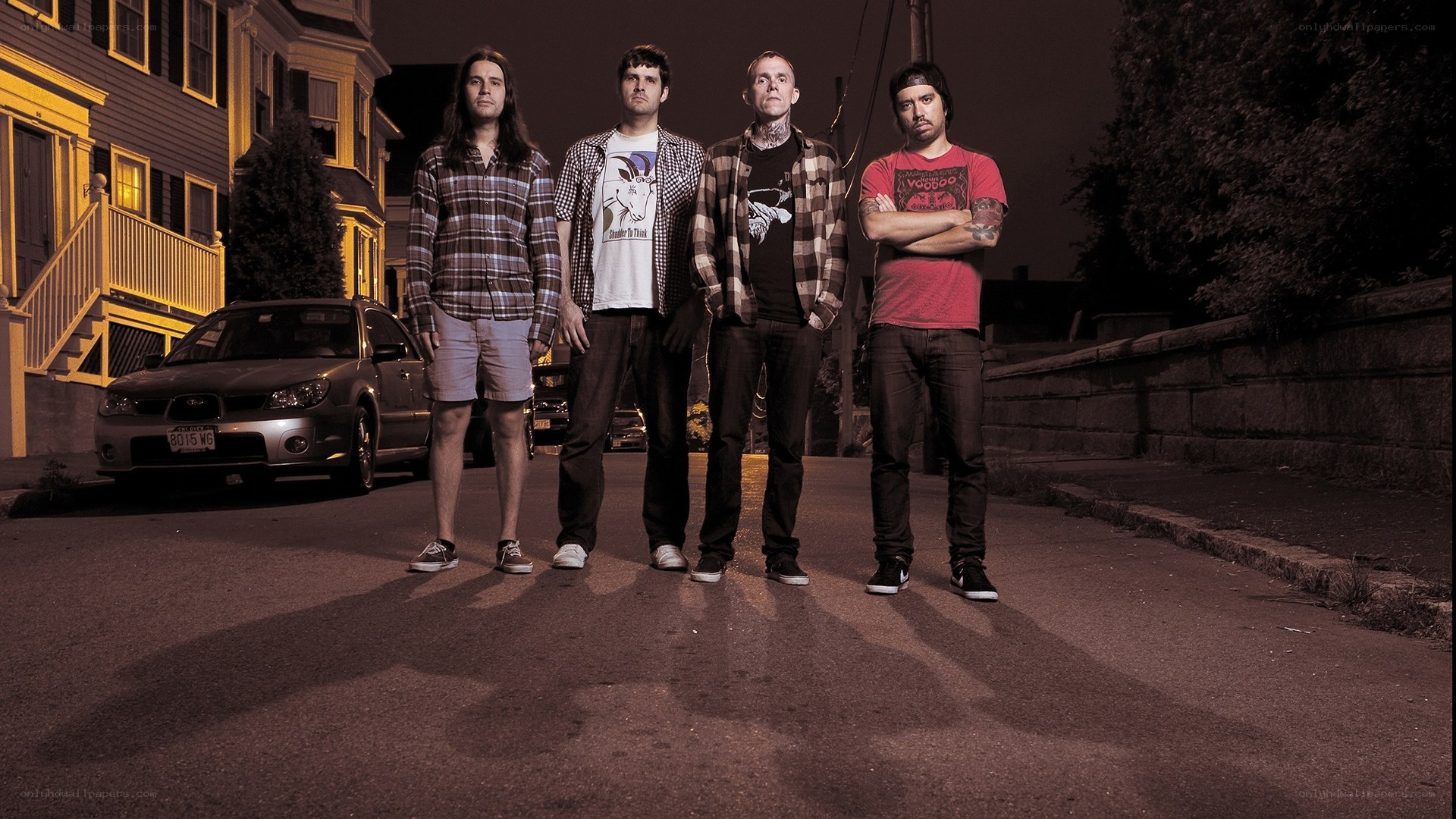 band standing on street at night