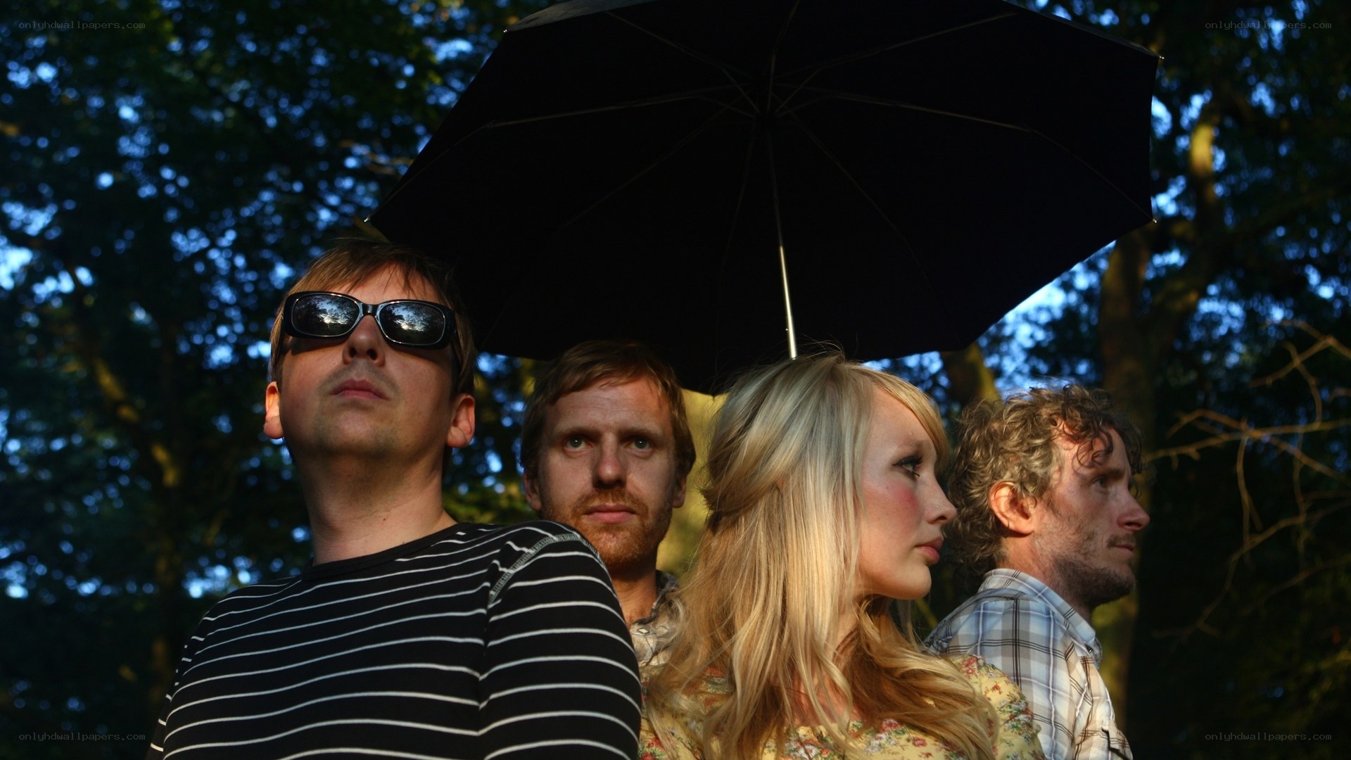 band under umbrella in park