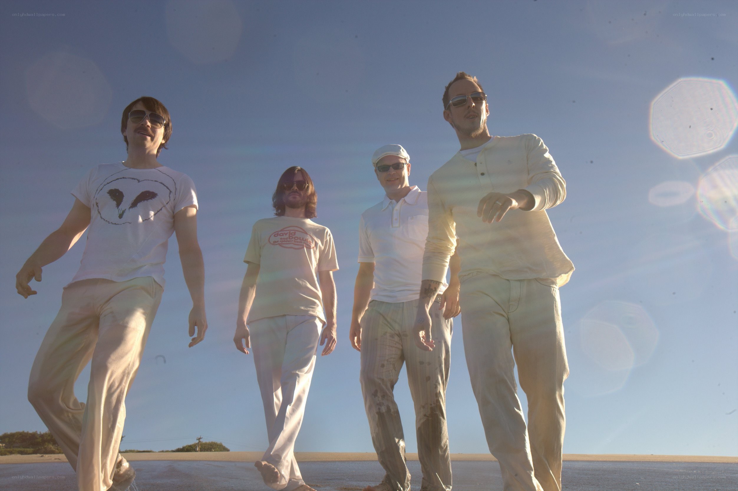 band walking on beach