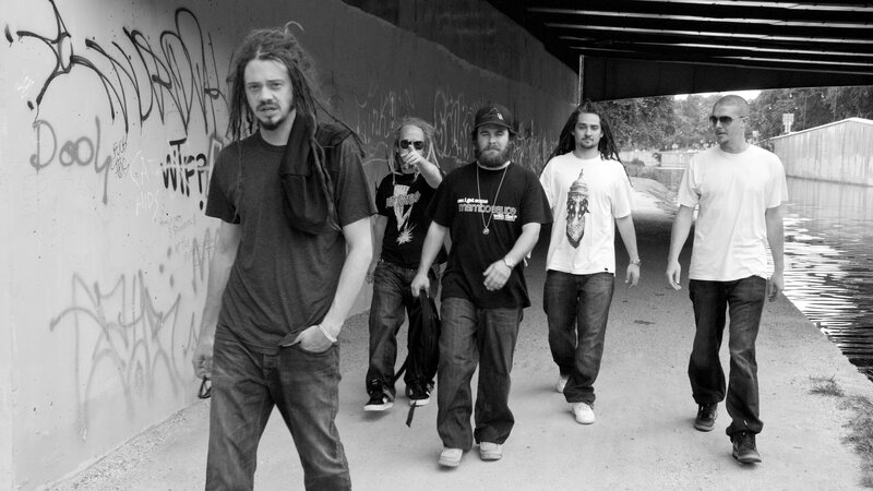 band walking under a bridge