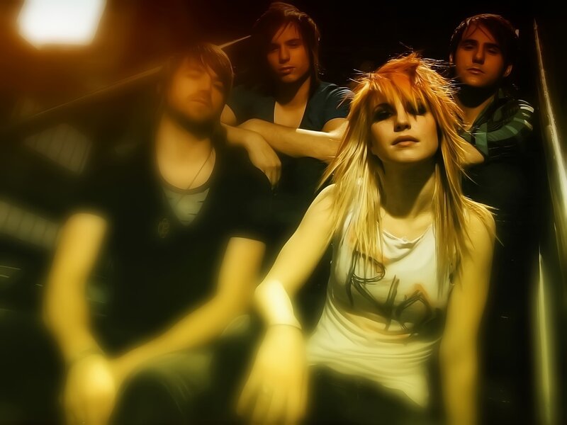 band with blonde woman in spotlight