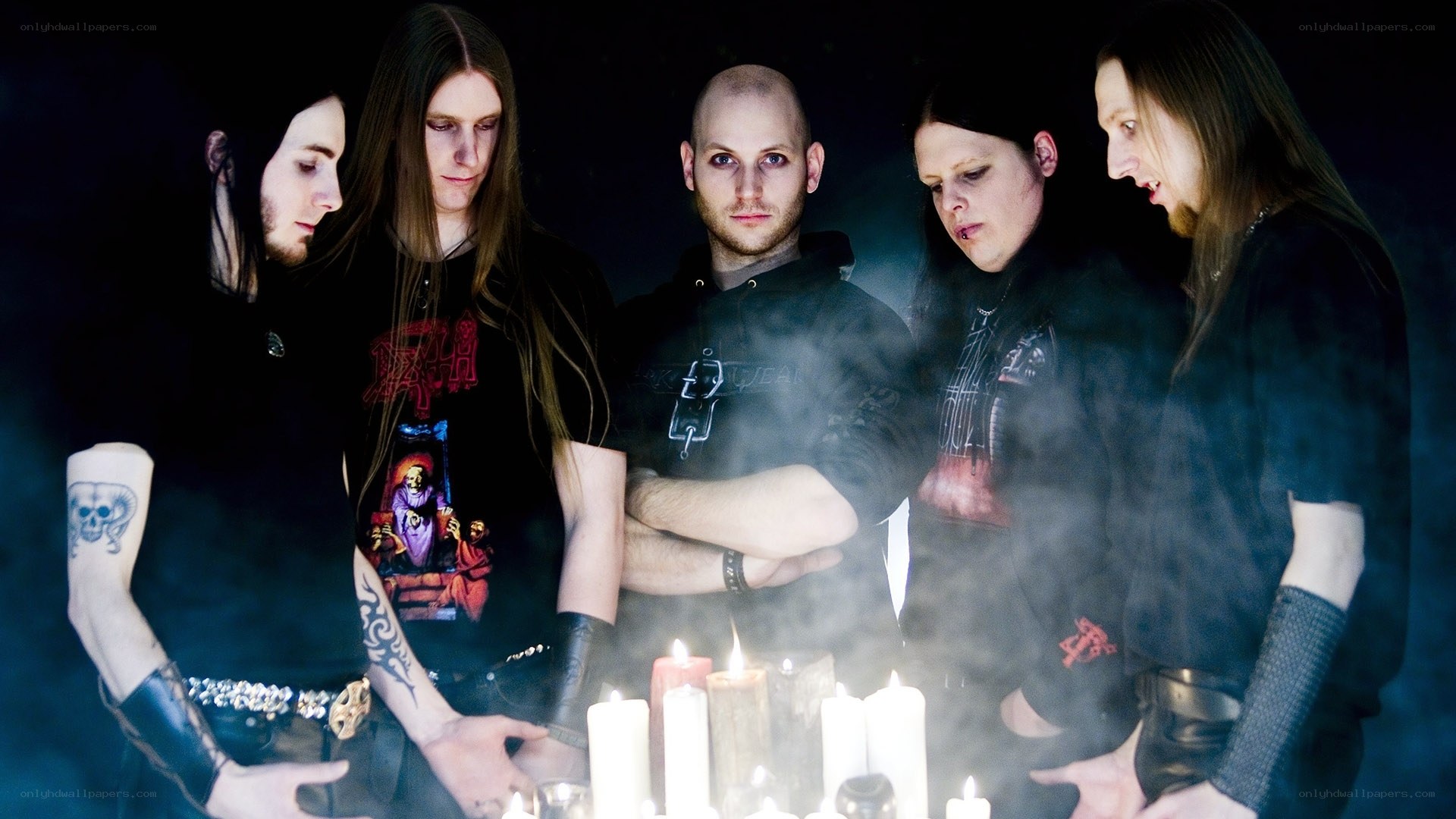 band with candles in dark room