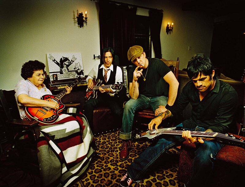 band with elderly woman playing guitar