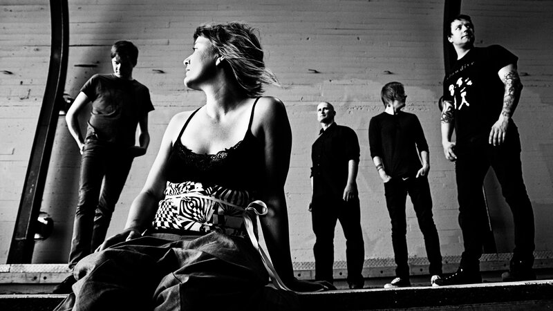 Band with female vocalist in black and white