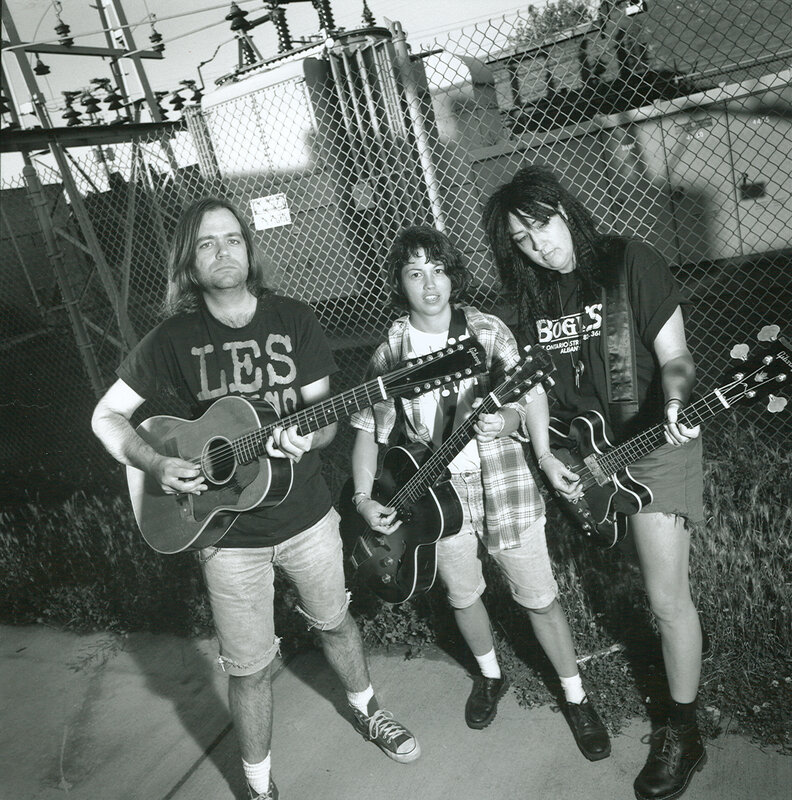 band with guitars in black and white