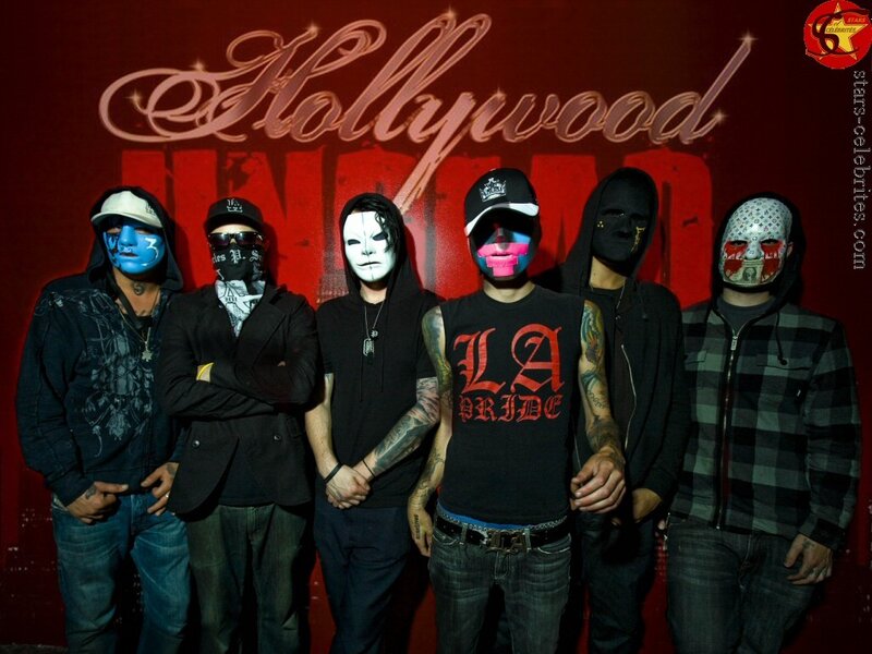 band with masks in front of hollywood sign