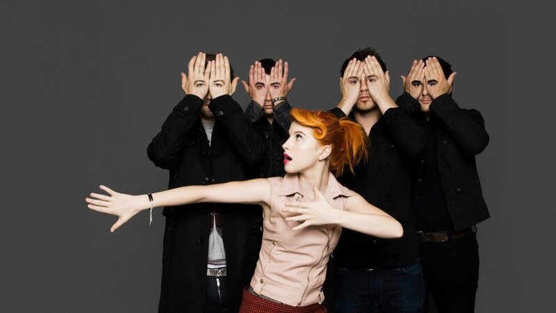 band with red-haired woman in front