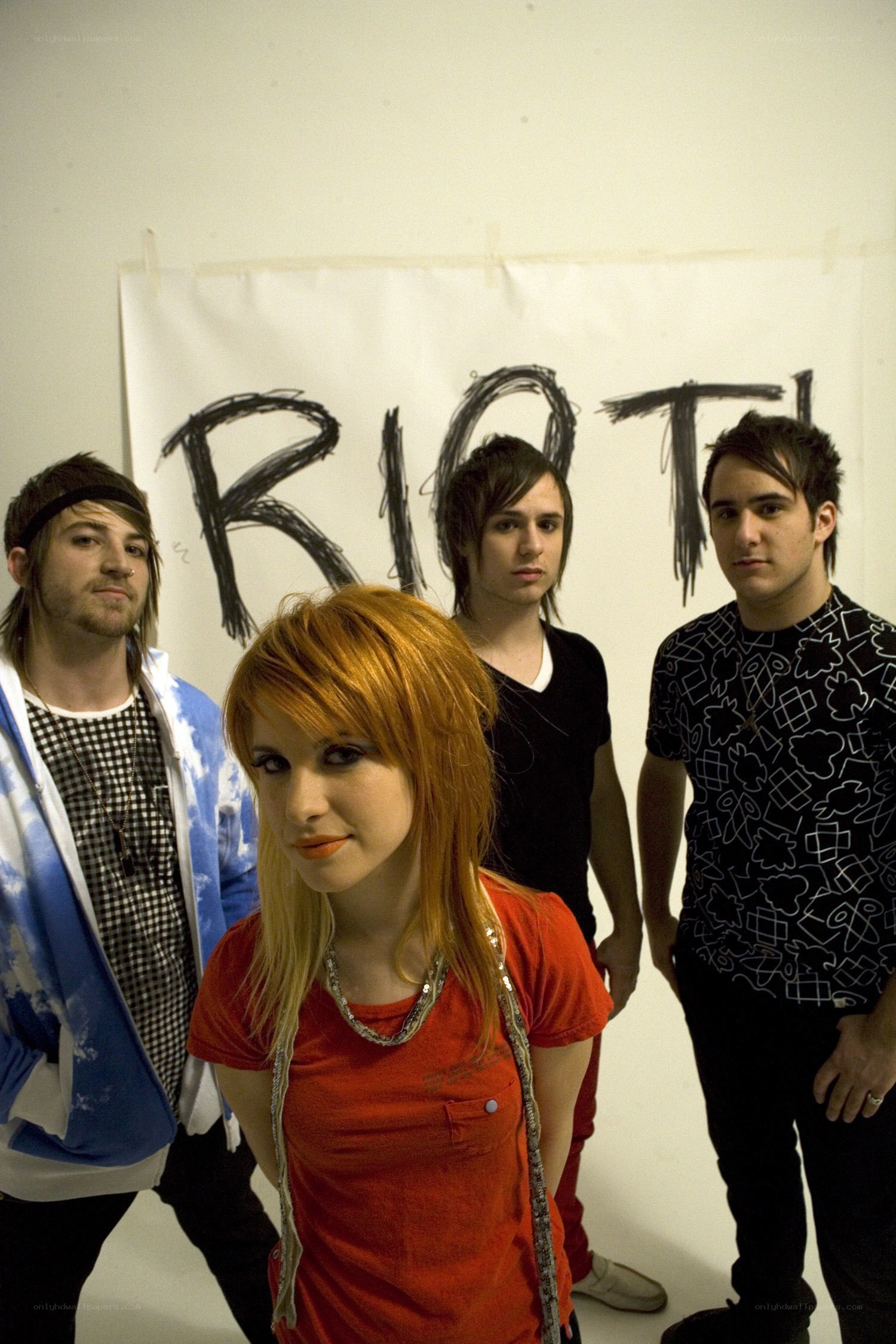 band with 'RIOT' sign