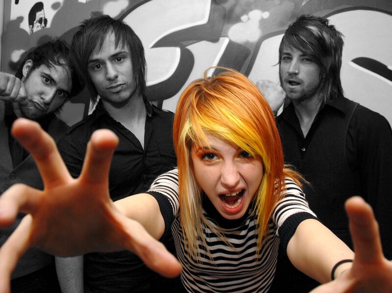 band with vibrant hair in foreground