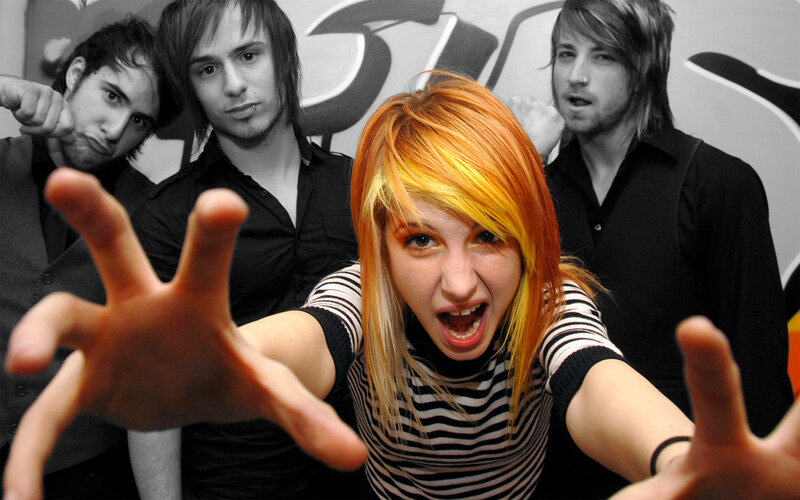 band with vibrant hair in foreground