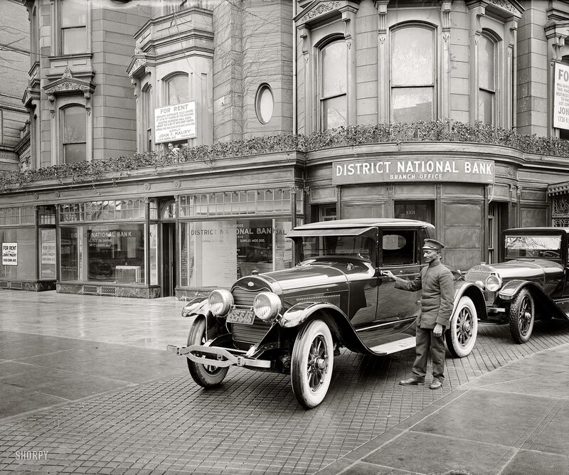 Bank and vintage cars on street