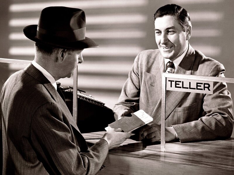 Bank teller assisting customer