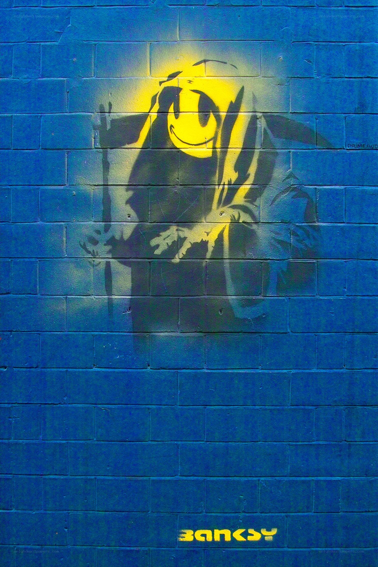 Banksy graffiti on blue wall