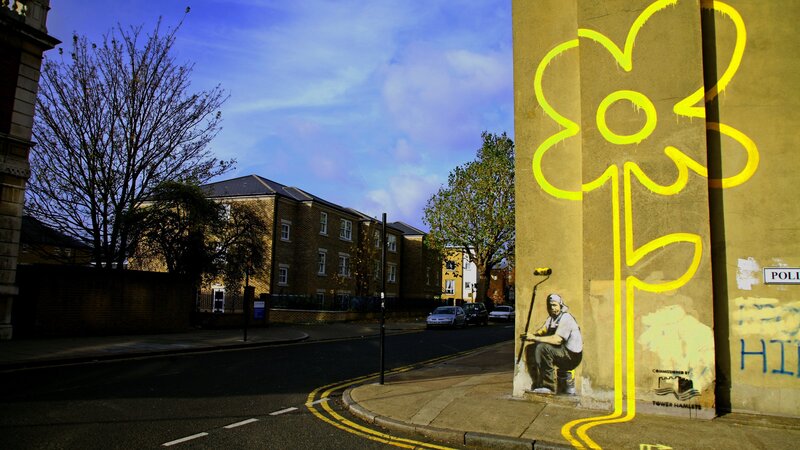 Banksy Graffiti on Wall — Yellow, Dramatic