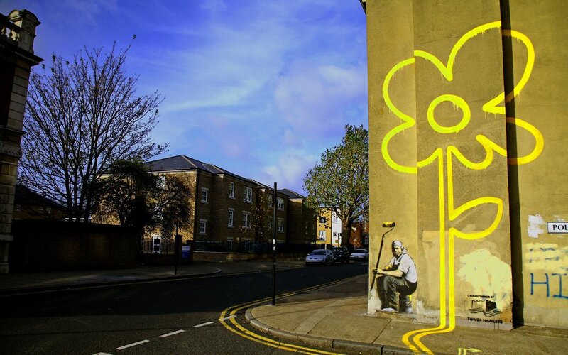 Banksy Graffiti on Wall — Yellow