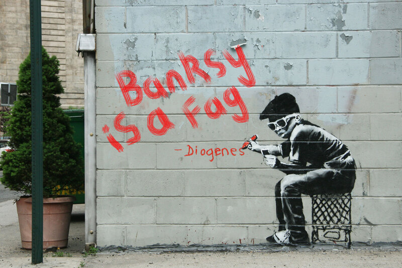 Banksy graffiti with red text