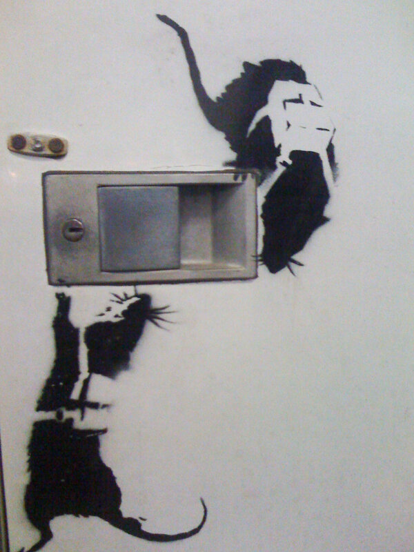 Banksy rat graffiti on door