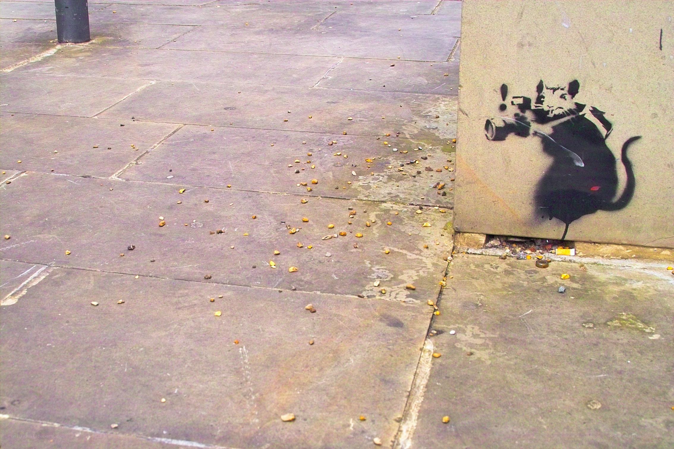Banksy rat graffiti on sidewalk