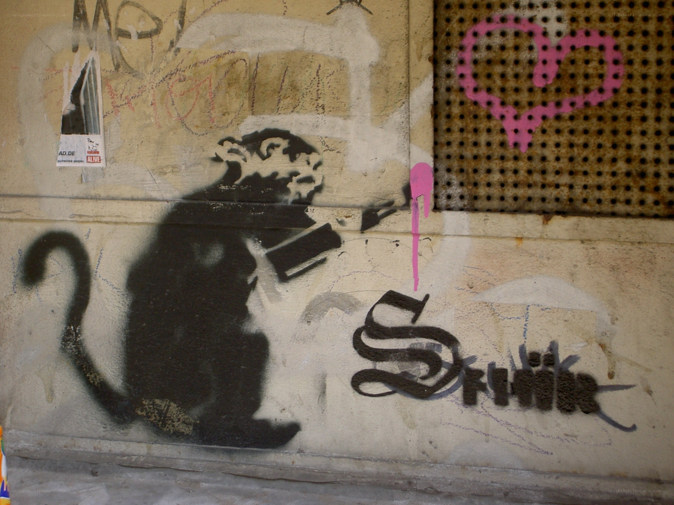 Banksy rat graffiti on wall