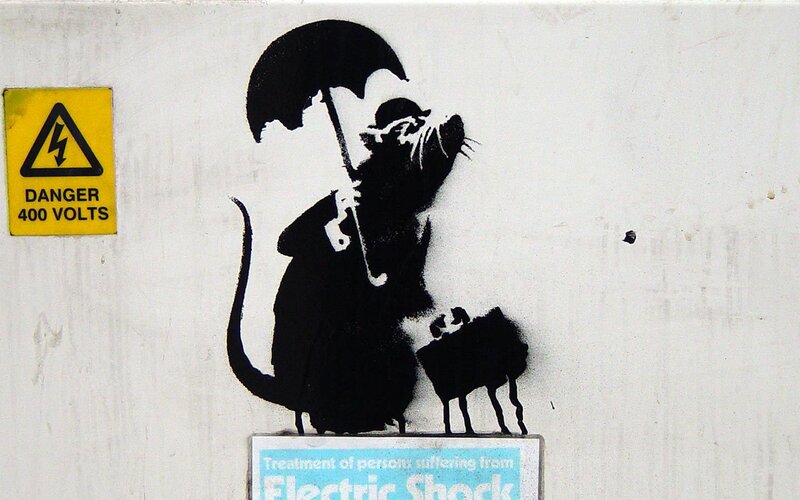 Banksy rat graffiti with umbrella