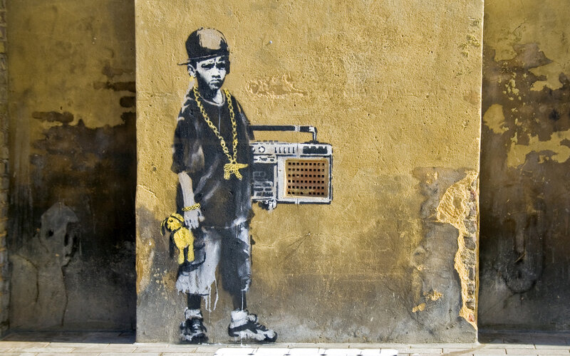 Banksy's graffiti of a boy with boombox