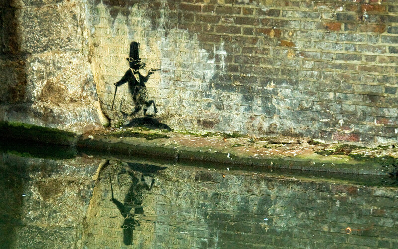 Banksy's rat graffiti on canal wall
