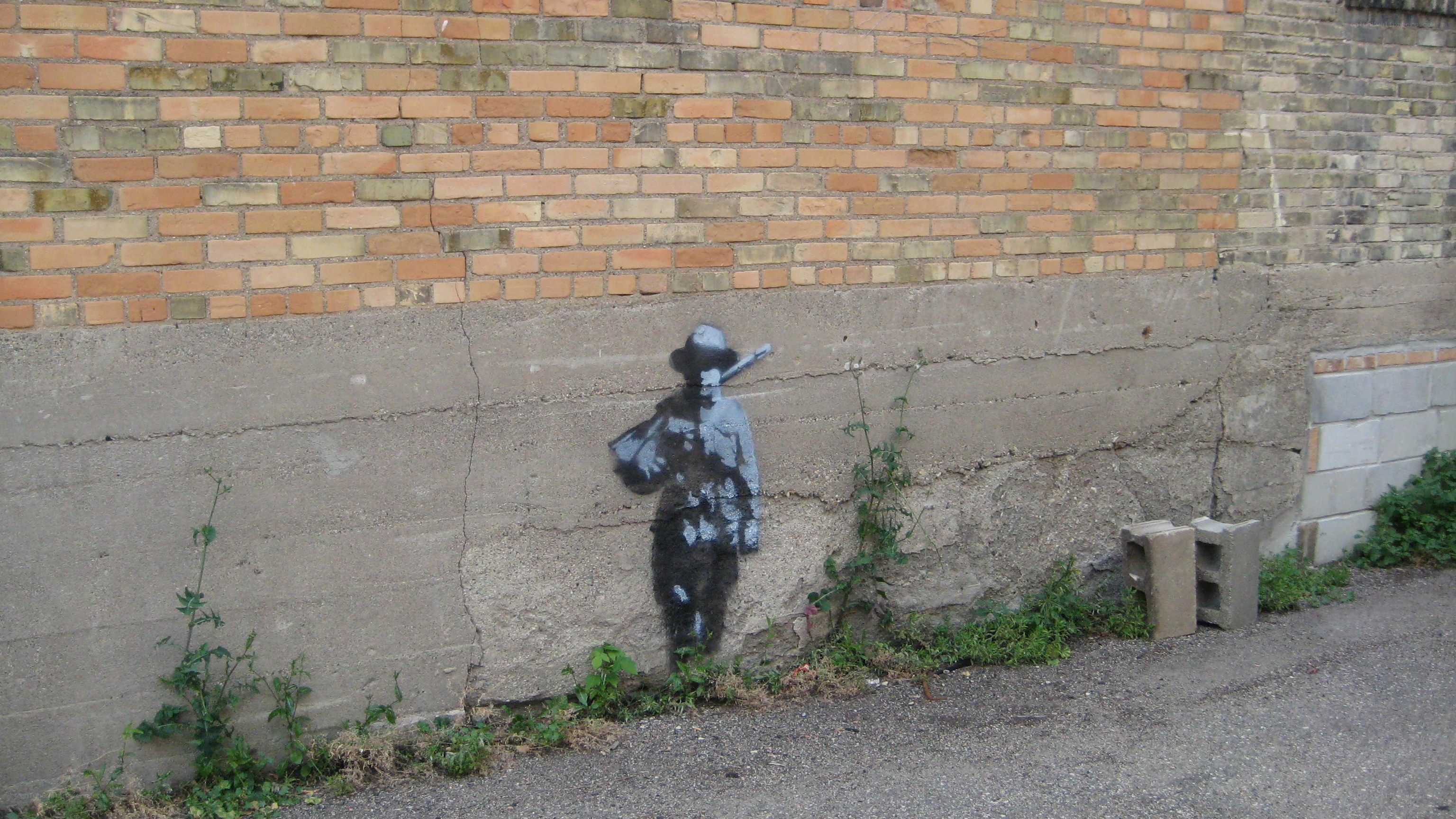 Banksy stencil on brick wall