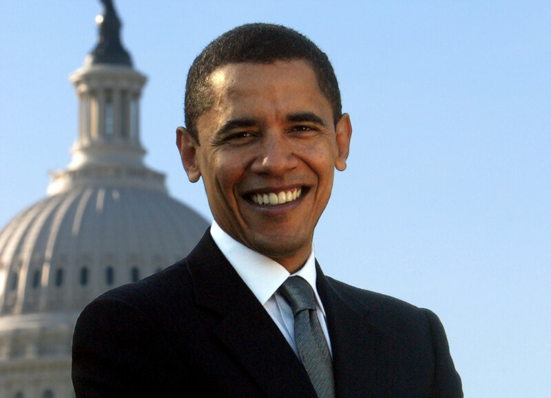Barack Obama smiling in front of Capitol