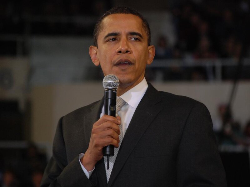 Barack Obama speaking into microphone
