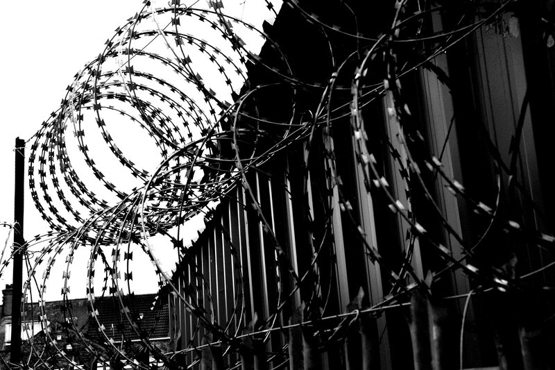 Barbed wire fence in black and white