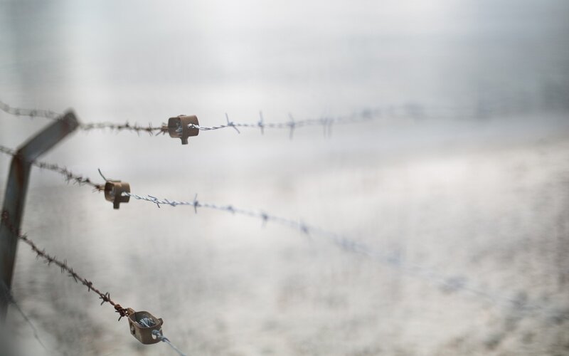 Barbed wire fence in fog