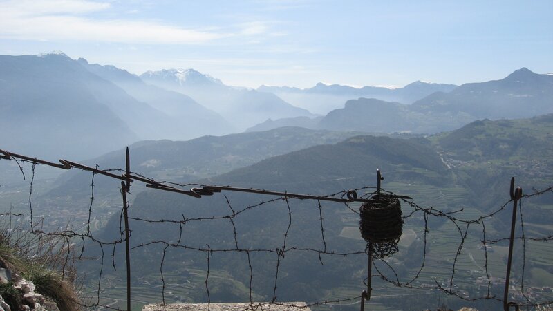 Barbed wire fence overlooking mountains