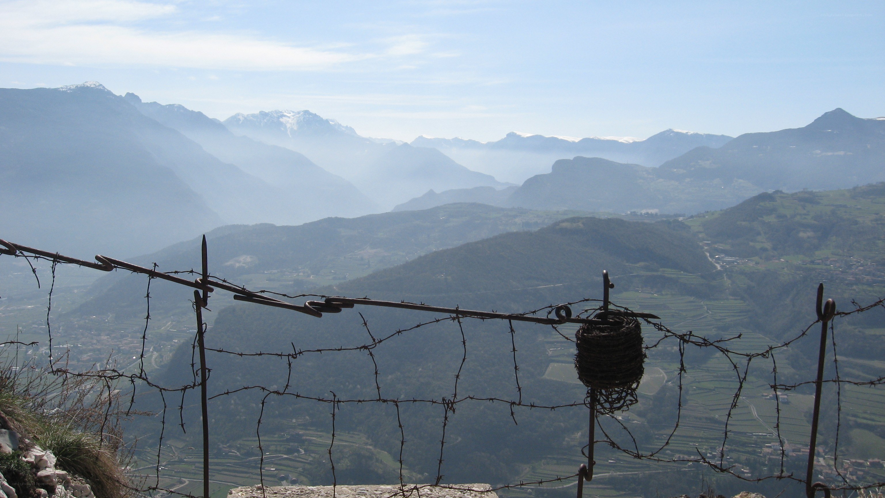 Barbed wire fence overlooking mountains