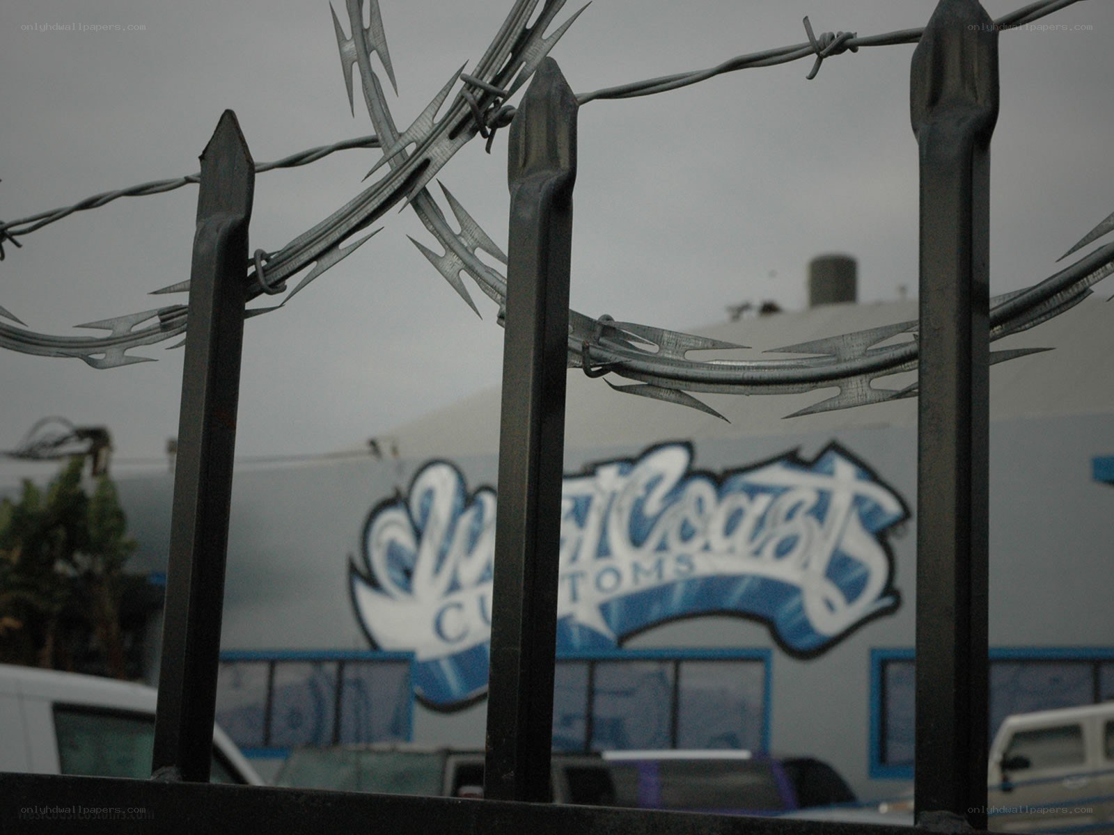 Barbed wire fence with building in background