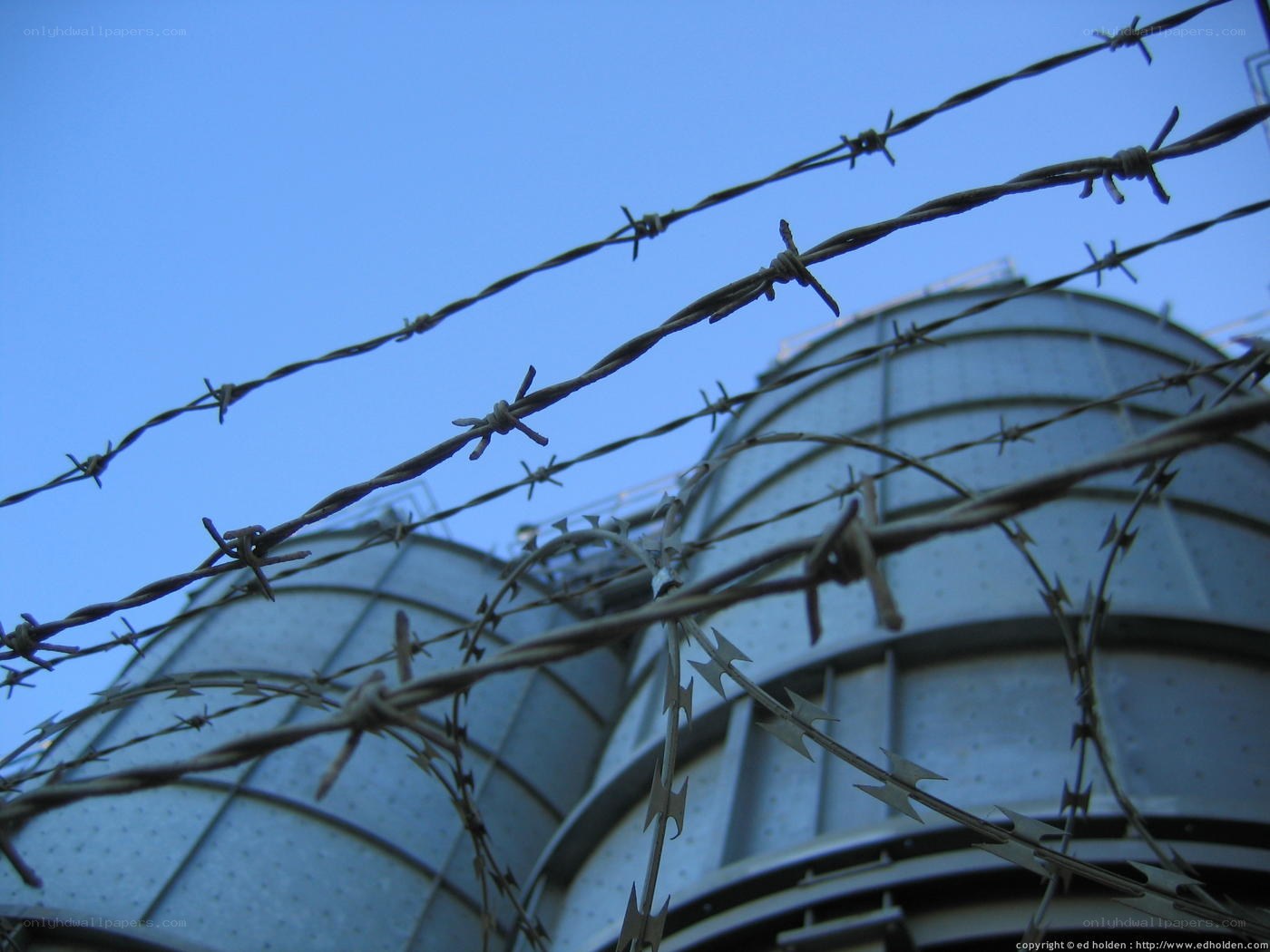 Barbed wire fence with silos