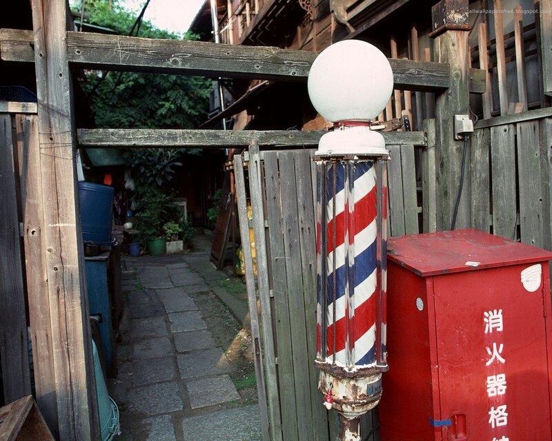 Barber pole in alleyway