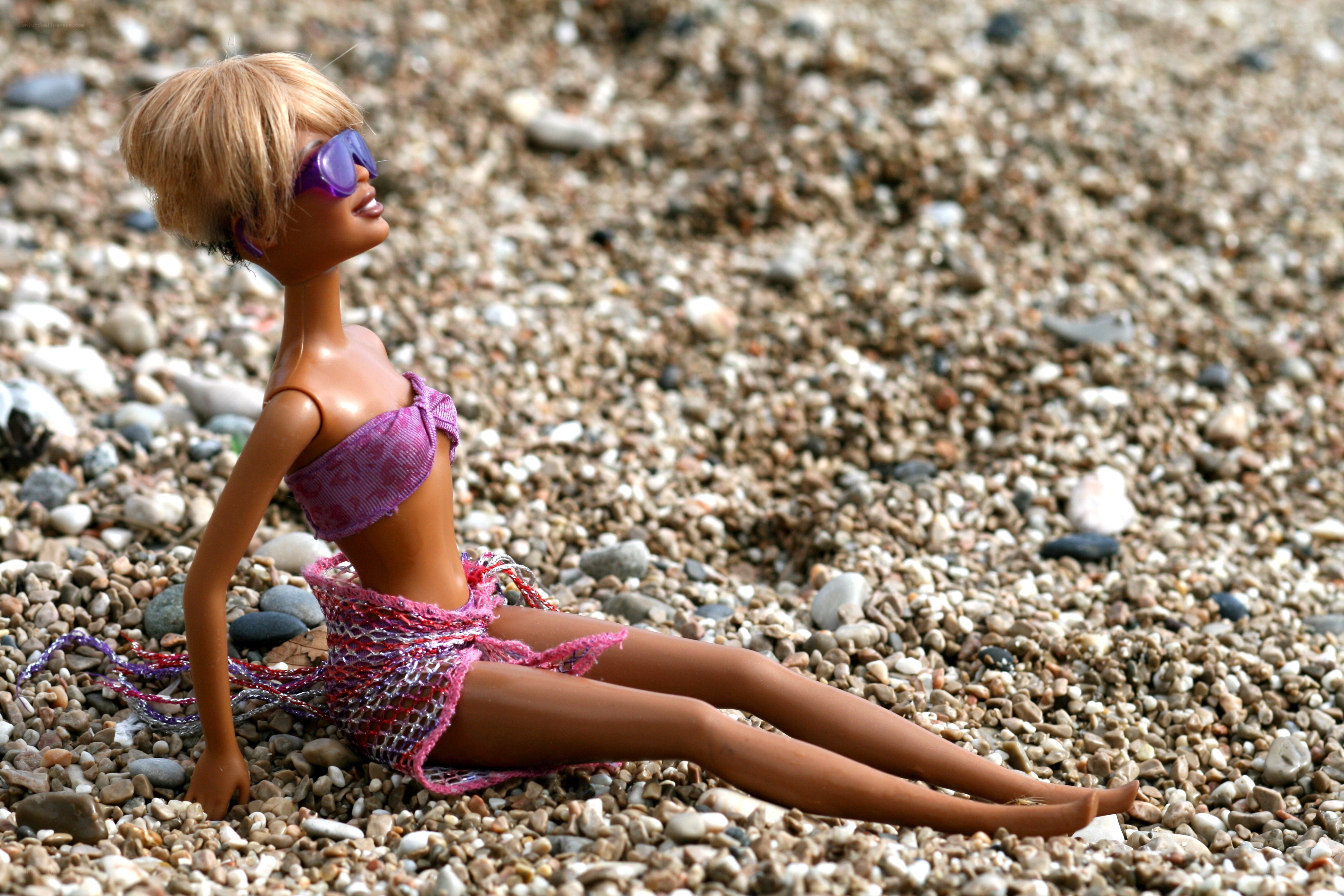 Barbie doll on pebble beach