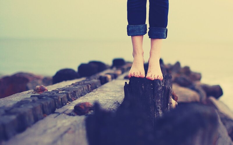 bare feet on a wooden beam