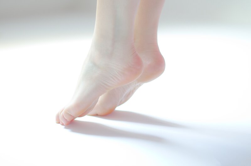 bare feet on white surface