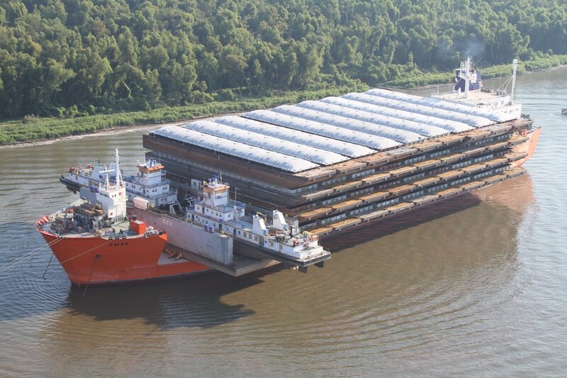 Barge carrying large cargo on river