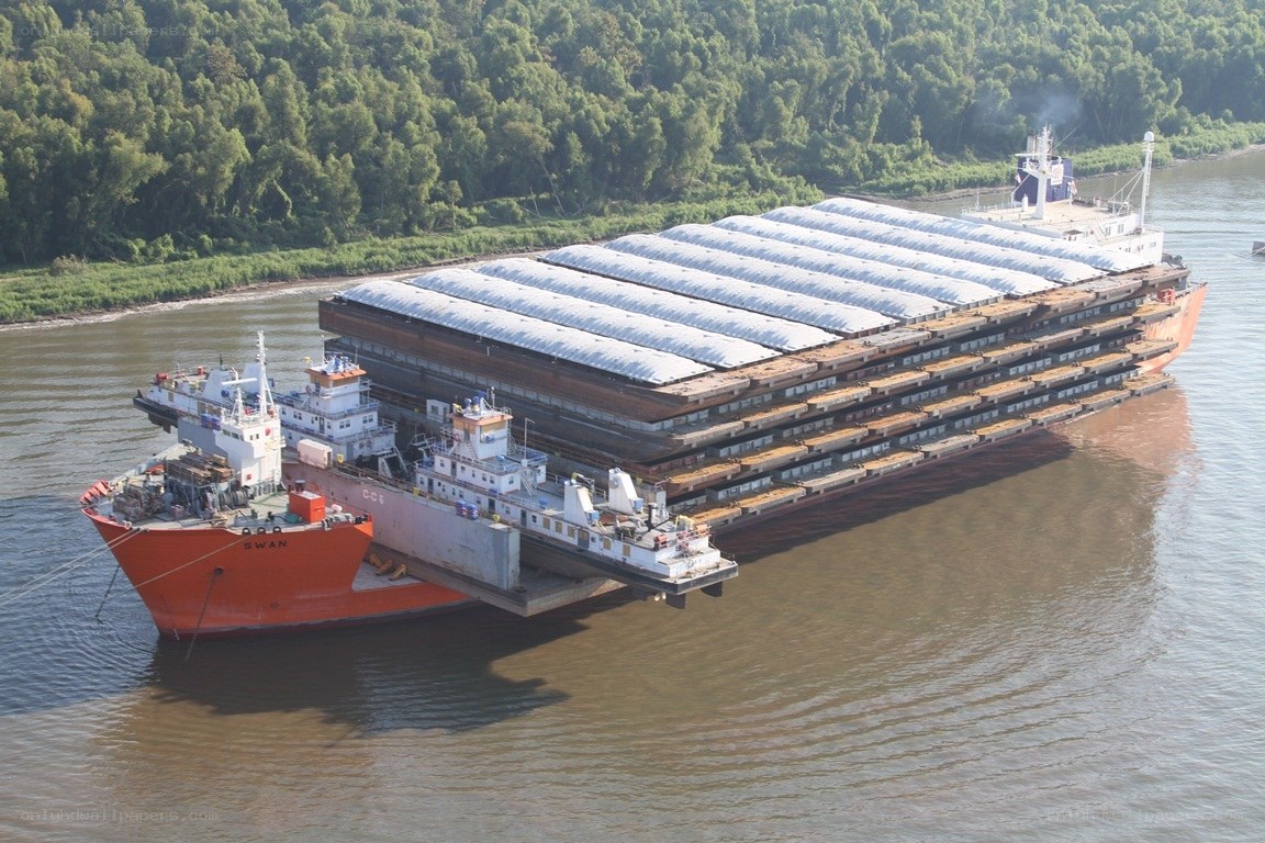 Barge carrying large cargo on river