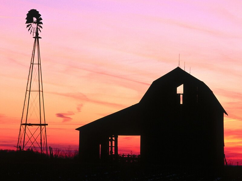 Barn and windmill at sunset