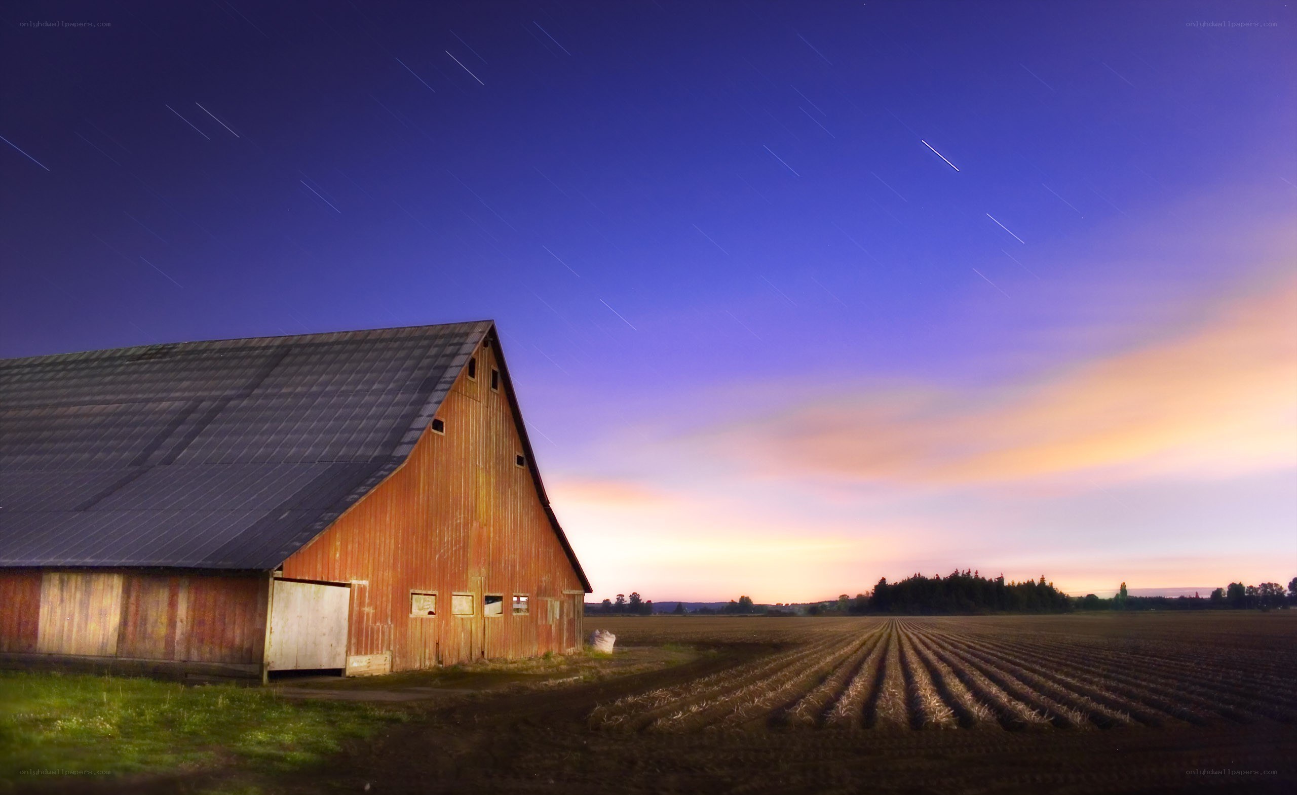 Barn at dusk with star trails