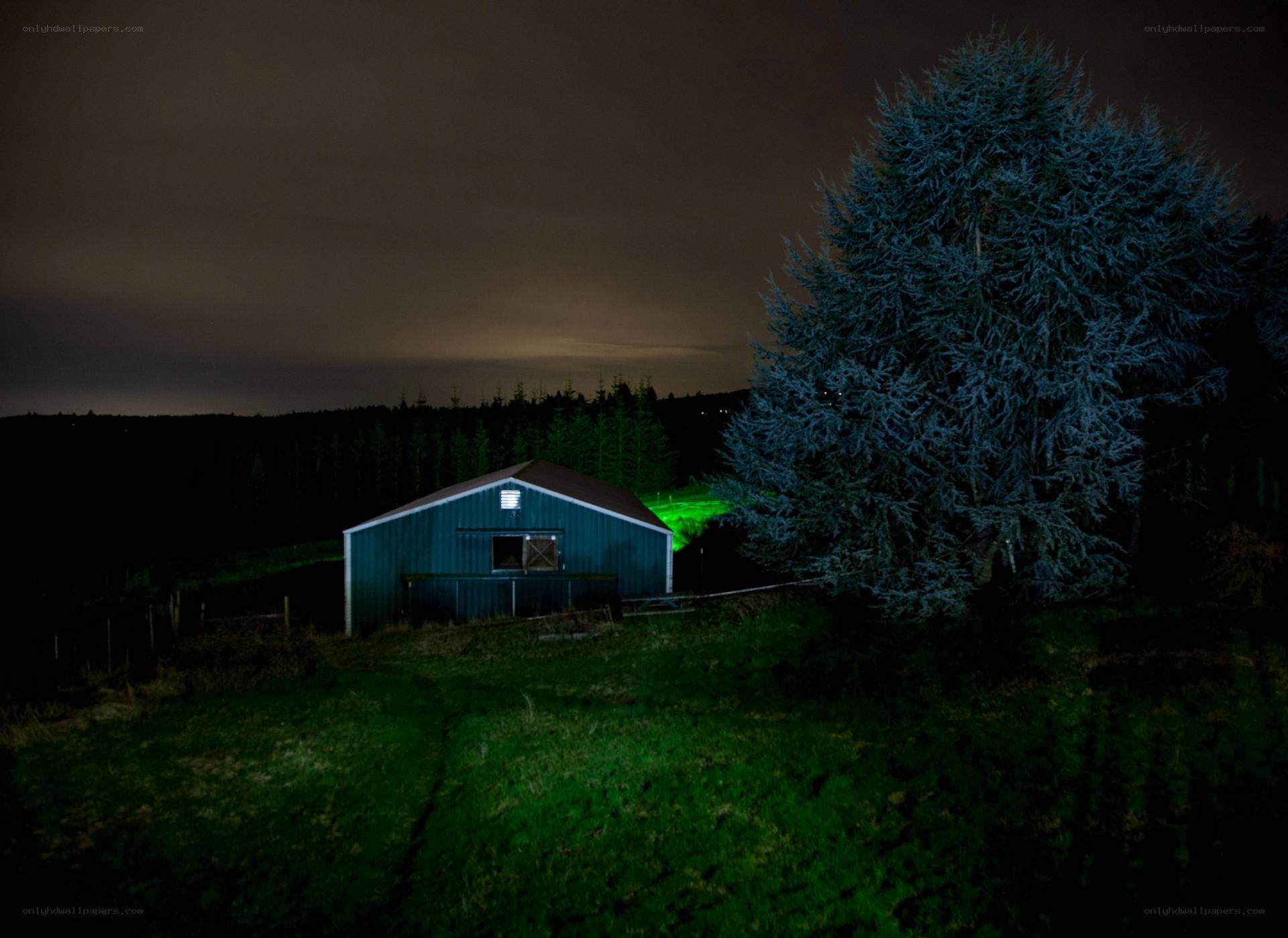 Barn at night with green light