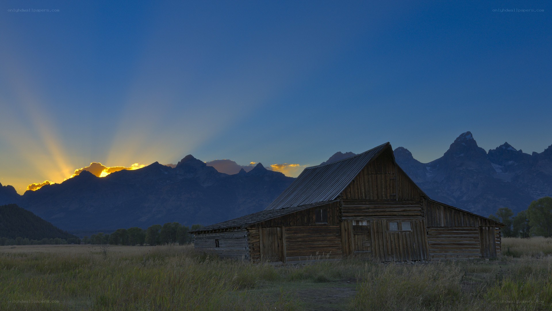 Barn at sunset with mountains