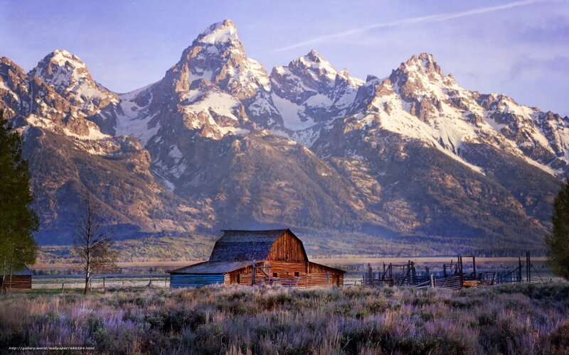 Barn in front of snow-capped mountains