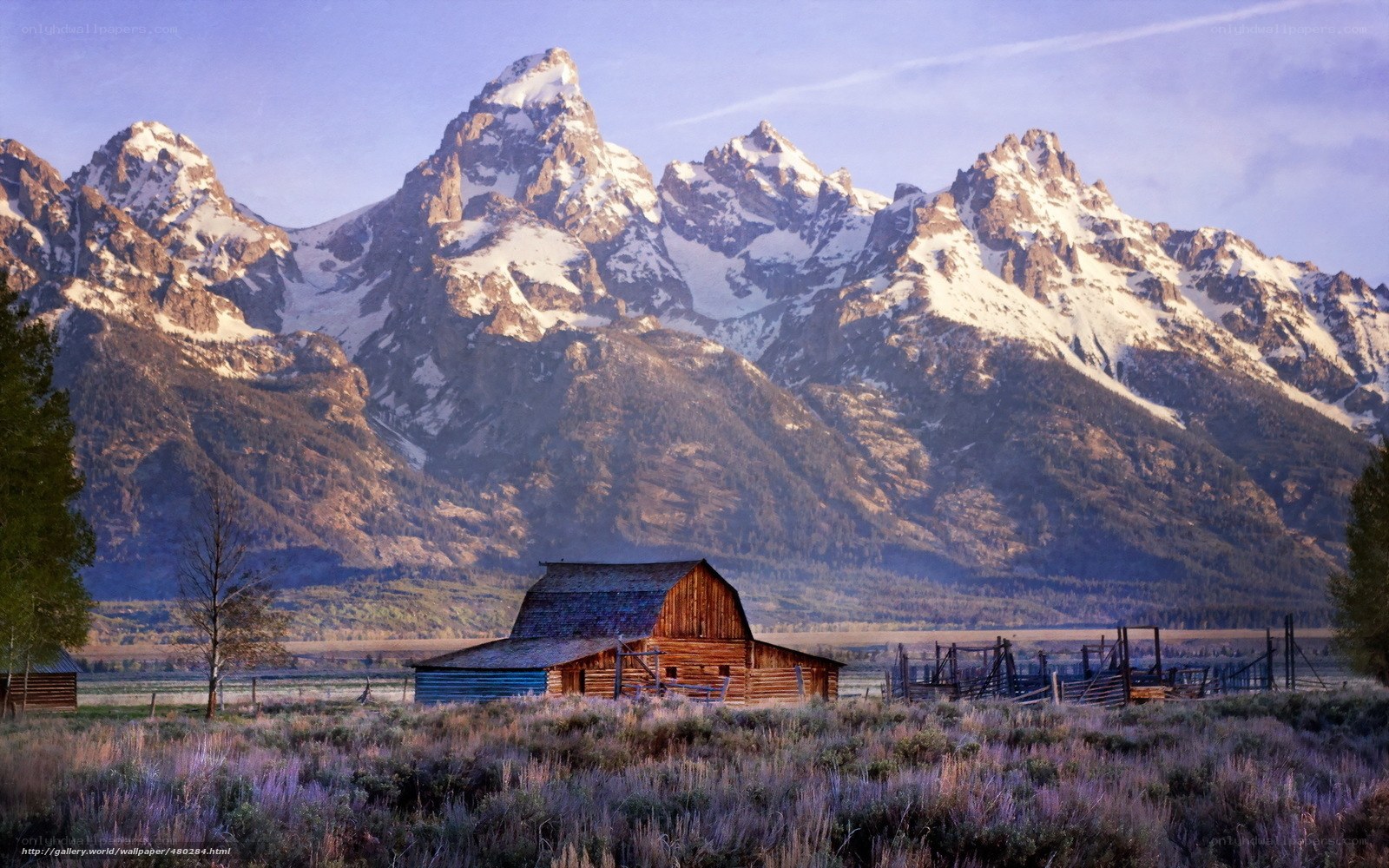 Barn in front of snow-capped mountains