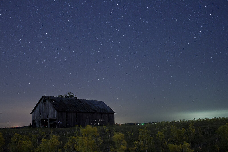 Barn under starry night sky