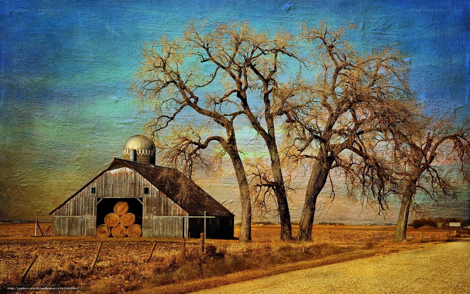 Barn with hay bales and trees